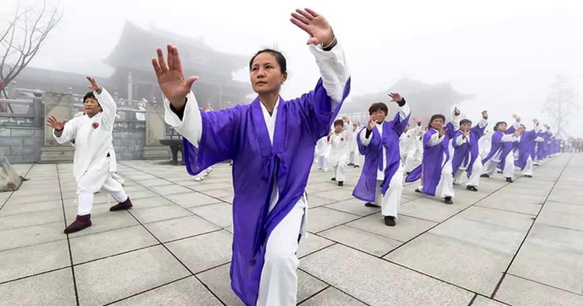 Chinese tai chi enthusiasts practiced on snow-covered mountains