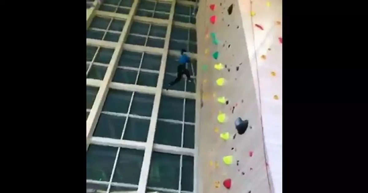 Staff of climbing gym falling  from four stories without attaching safety harness hits ground to unresponsiveness