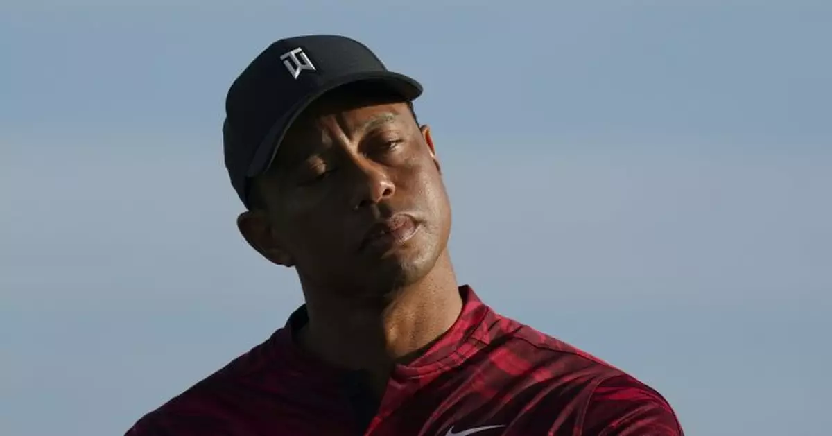 Tiger Woods returns with a little help from his son