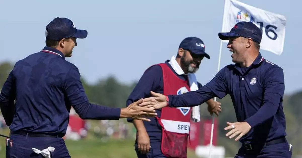 Spieth and caddie looking for an edge in reading putts