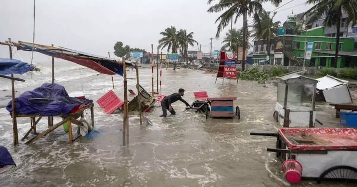 A tropical storm floods villages and cuts power to millions in parts of Bangladesh and India