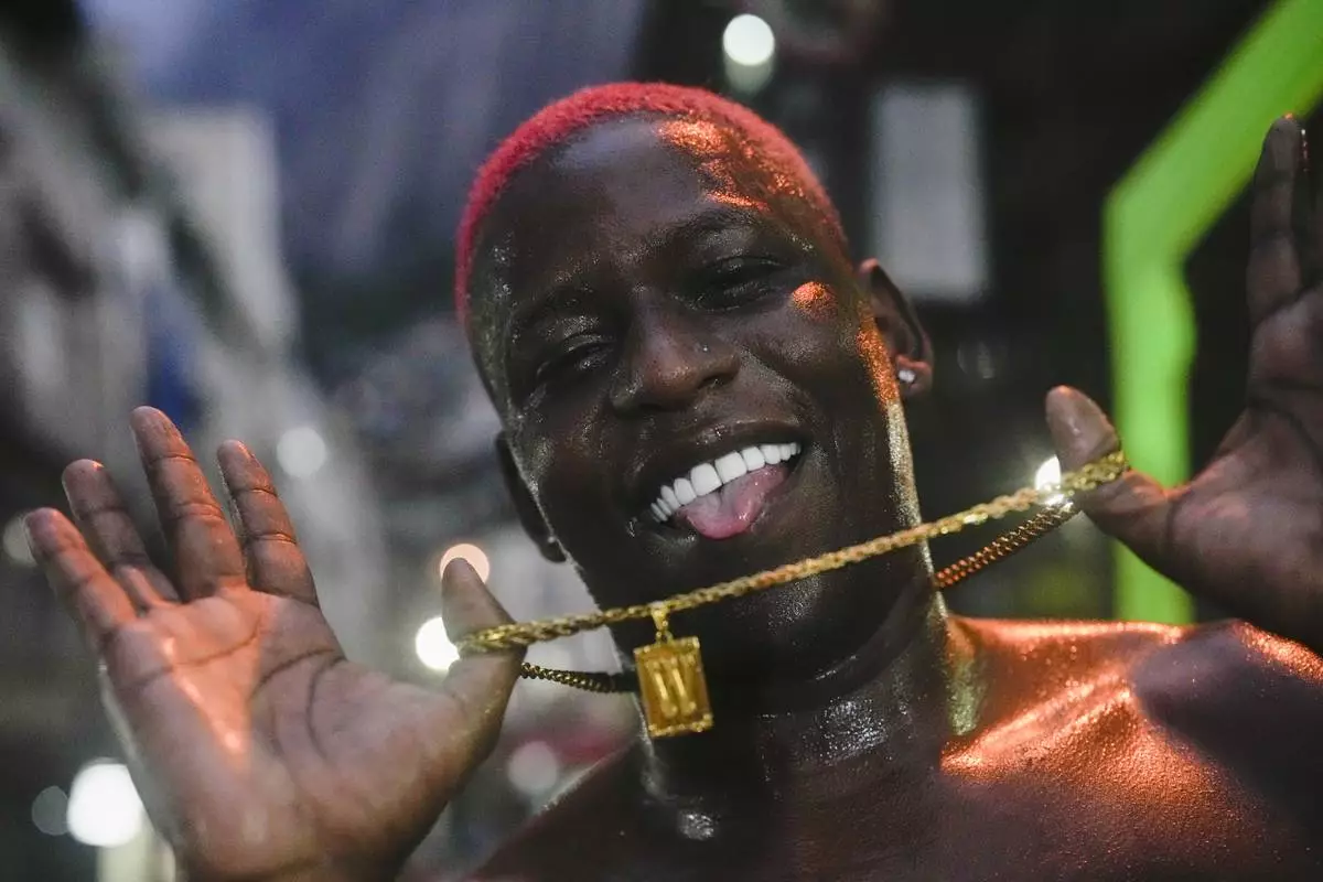 FILE - A youth strikes a pose after performing street dance style known as passinho in the Rocinha favela of Rio de Janeiro, Brazil, Thursday, April 11, 2024. The passinho, or "little step", created in the 2000s by kids in Rio's favelas, was declared an "intangible cultural heritage" by state legislators, bringing recognition to a cultural expression born in the sprawling working-class neighborhoods. (AP Photo/Silvia Izquierdo, File)