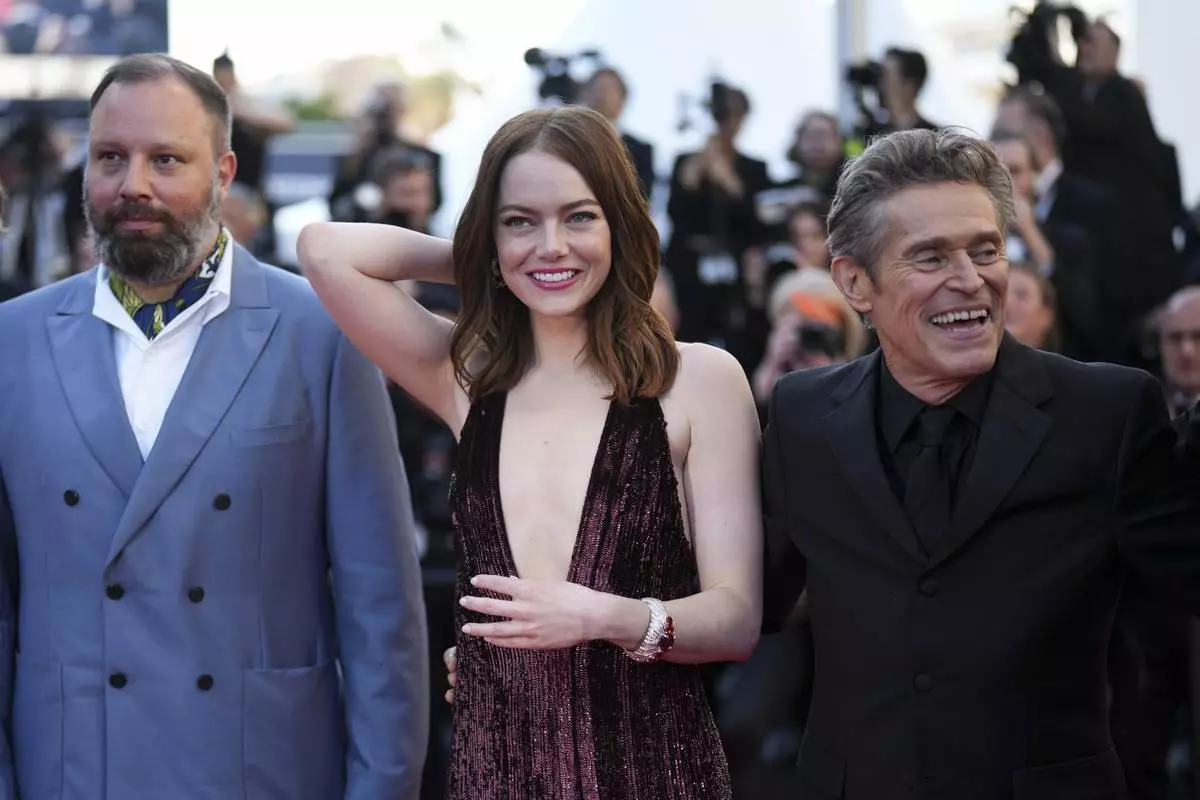 Director Yorgos Lanthimos, from left, Emma Stone, and Willem Dafoe pose for photographers upon arrival at the premiere of the film 'Kinds of Kindness' at the 77th international film festival, Cannes, southern France, Friday, May 17, 2024. (Photo by Scott A Garfitt/Invision/AP)