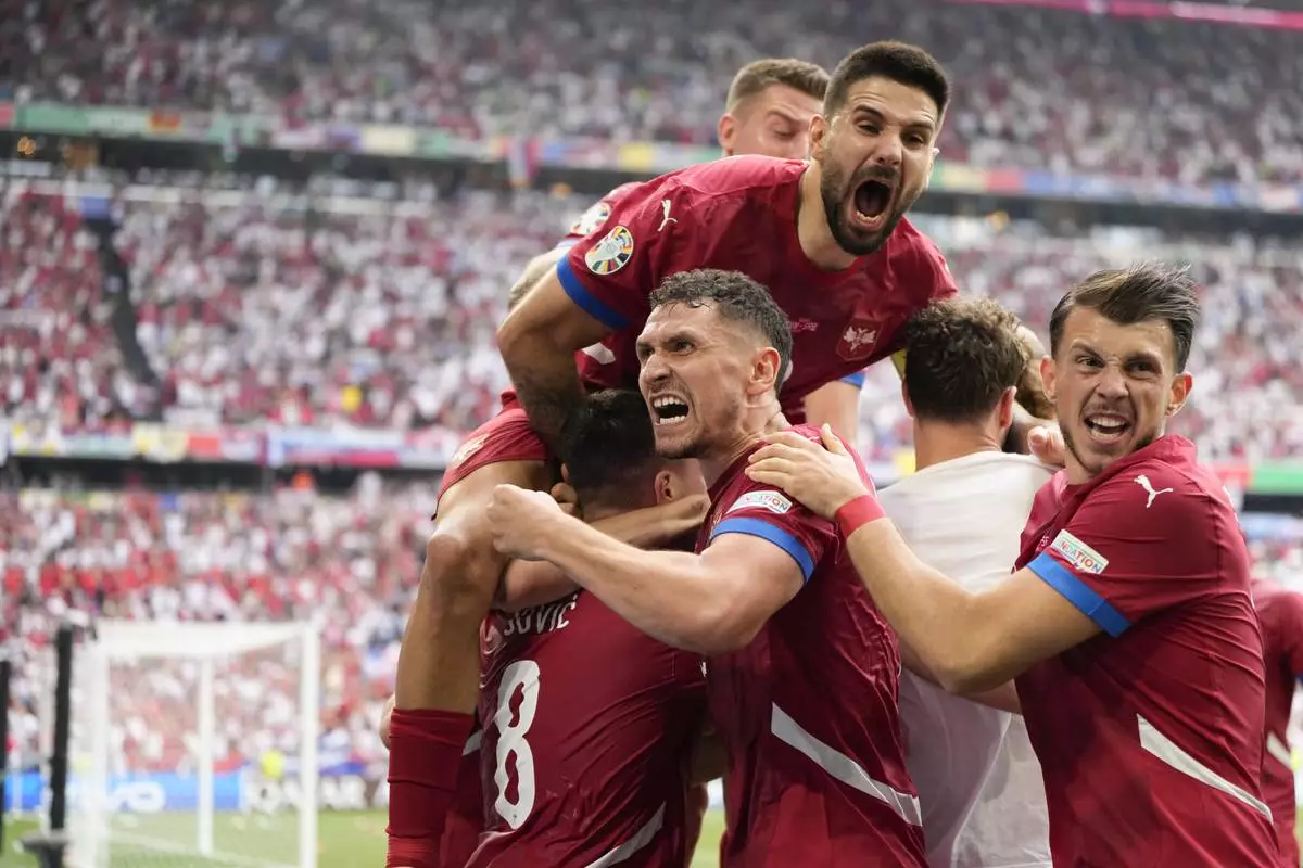 Serbia players celebrate their team's first goal against Slovenia during the Group C match between Slovenia and Serbia during the Euro 2024 soccer tournament in Munich, Germany, Thursday, June 20, 2024. (AP Photo/Matthias Schrader)