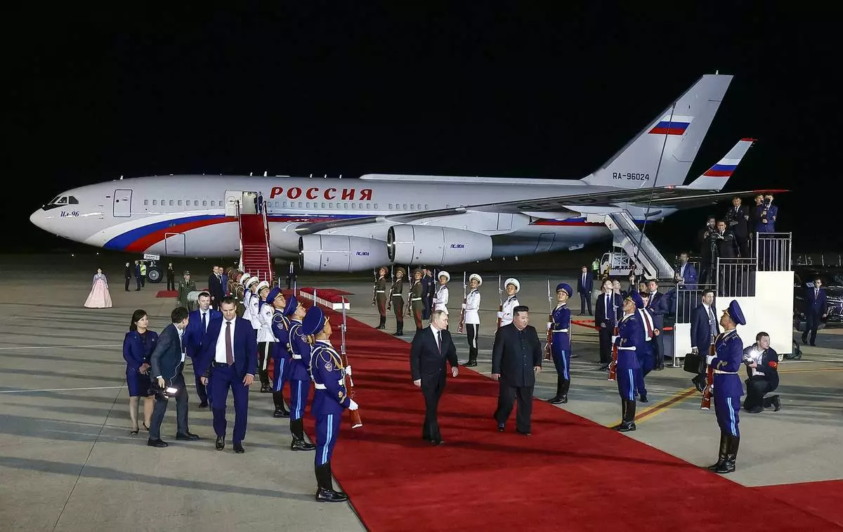 CORRECTS DATE TO EARLY WEDNESDAY, JUNE 19 - Russian President Vladimir Putin, center left, and North Korea's leader Kim Jong Un, center right, walk together during their meeting at the Pyongyang Sunan International Airport outside Pyongyang, North Korea, early Wednesday, June 19, 2024. (Vladimir Smirnov, Sputnik, Kremlin Pool Photo via AP)