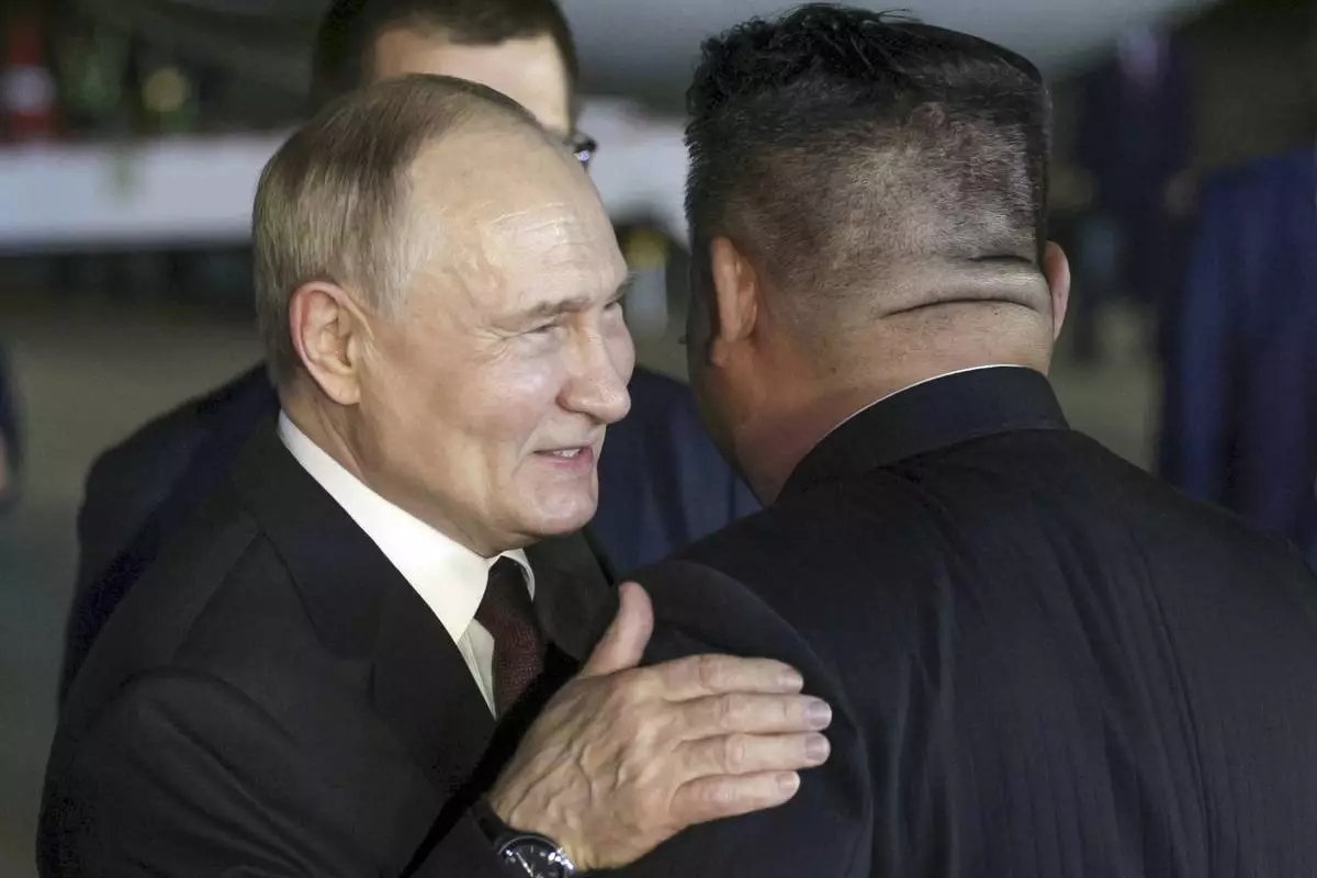 CORRECTS DATE TO EARLY WEDNESDAY, JUNE 19 - Russian President Vladimir Putin, left, and North Korea's leader Kim Jong Un greet each other during their meeting at the Pyongyang Sunan International Airport outside Pyongyang, North Korea, early Wednesday, June 19, 2024. (Gavriil Grigorov, Sputnik, Kremlin Pool Photo via AP)