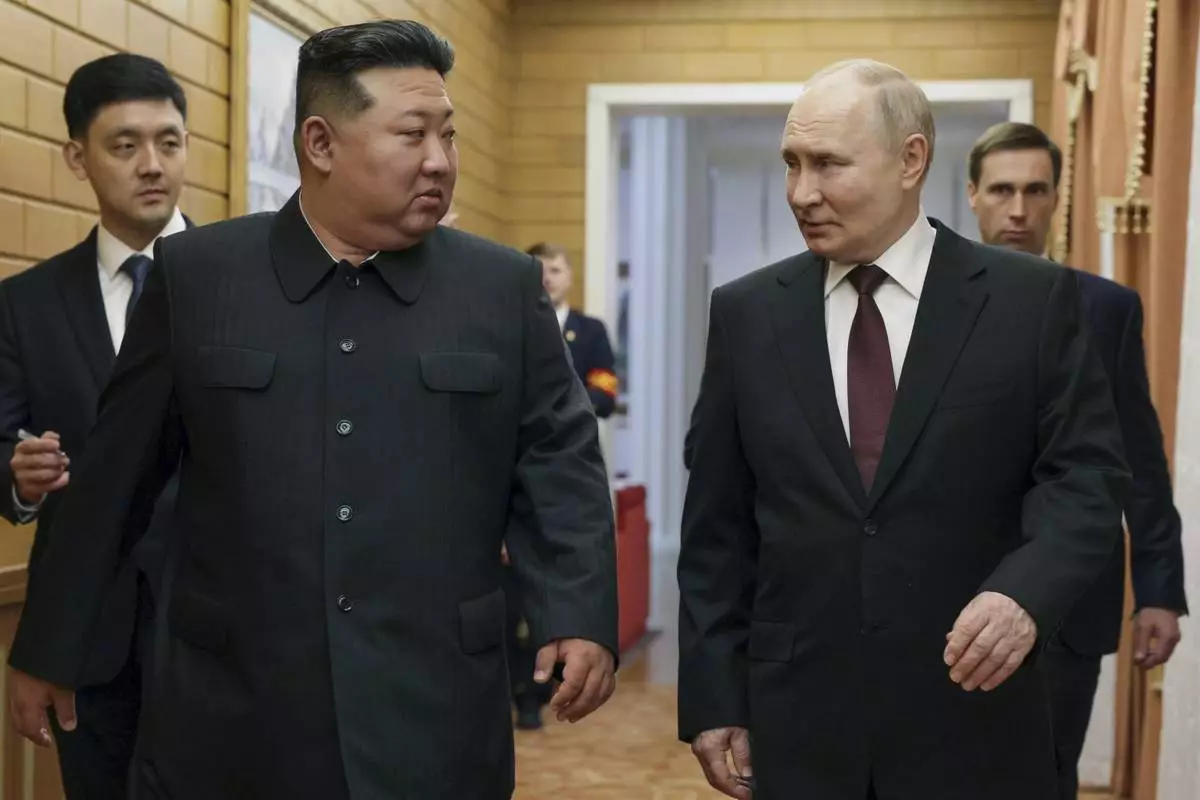 CORRECTS DATE TO EARLY WEDNESDAY, JUNE 19 - Russian President Vladimir Putin, right, and North Korea's leader Kim Jong Un talk to each other during their meeting in Pyongyang, North Korea, early Wednesday, June 19, 2024. (Gavriil Grigorov, Sputnik, Kremlin Pool Photo via AP)
