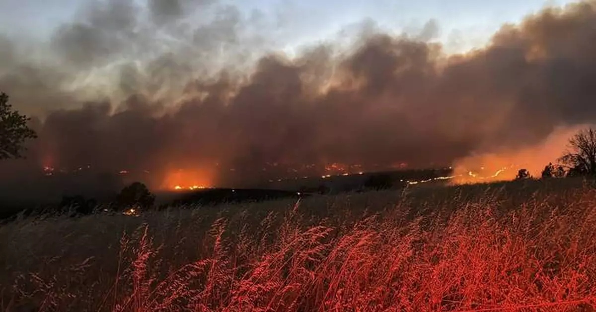 Gusty winds help spread fast growing central Oregon wildfire and prompt evacuations