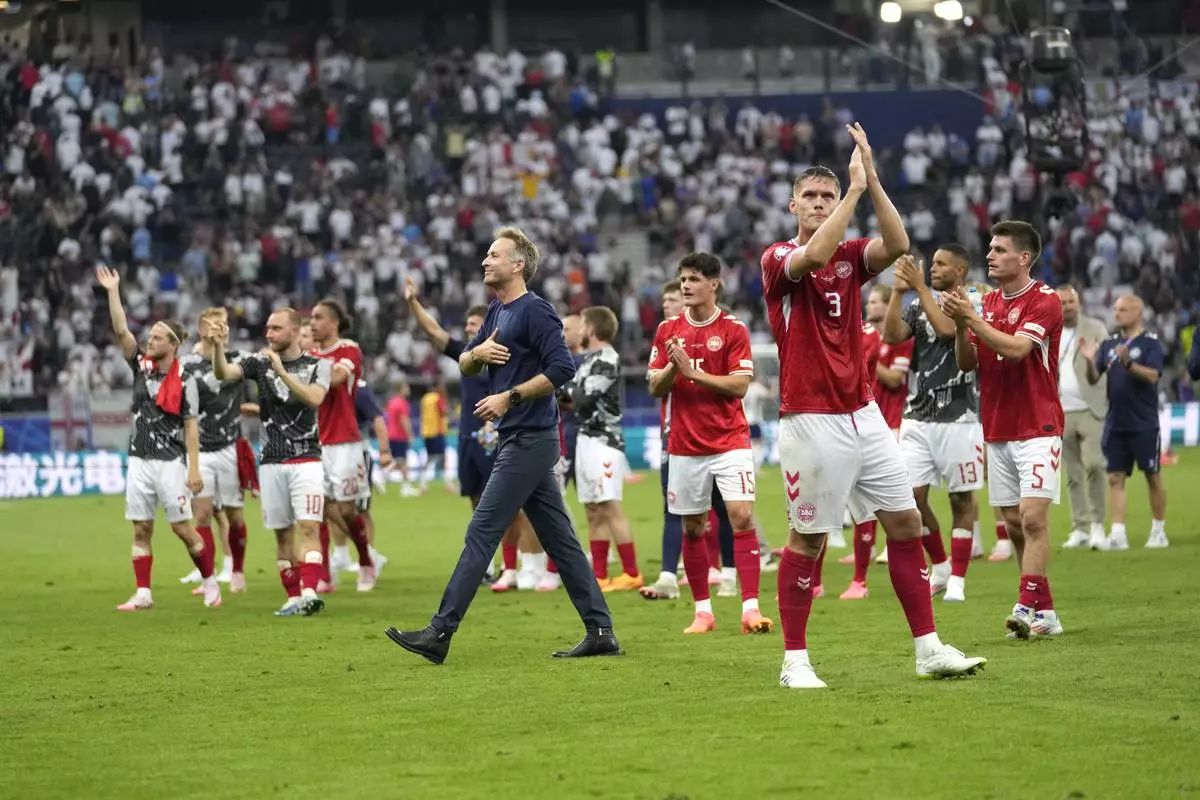 Denmark head coach Kasper Hjulmand and players at the conclusion of the Group C match between Denmark and England during the Euro 2024 soccer tournament in Frankfurt, Germany, Thursday, June 20, 2024. (AP Photo/Sergei Grits)