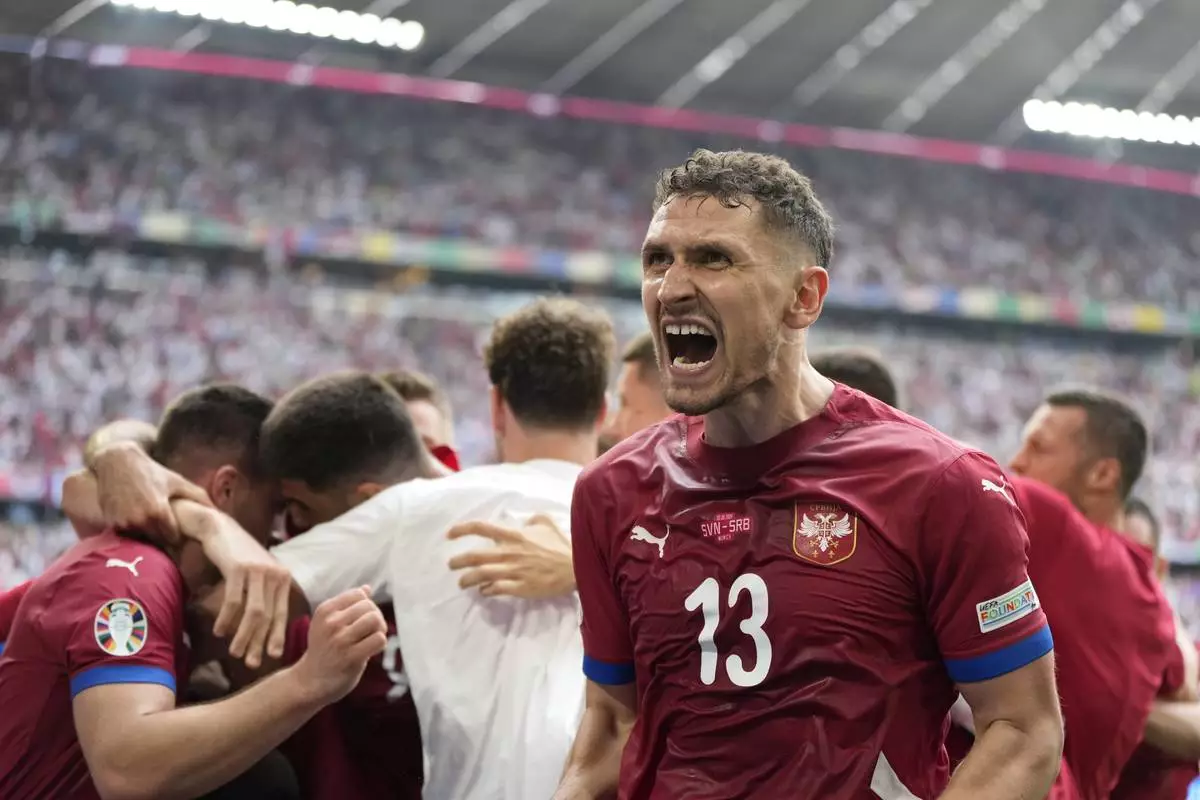 Serbia's Milos Veljkovic (right) celebrates his first goal against Slovenia with teammates during the Group C match between Slovenia and Serbia during the Euro 2024 soccer tournament in Munich, Germany, Thursday, June 20, 2024. (AP Photo/ Matthias Schrader)