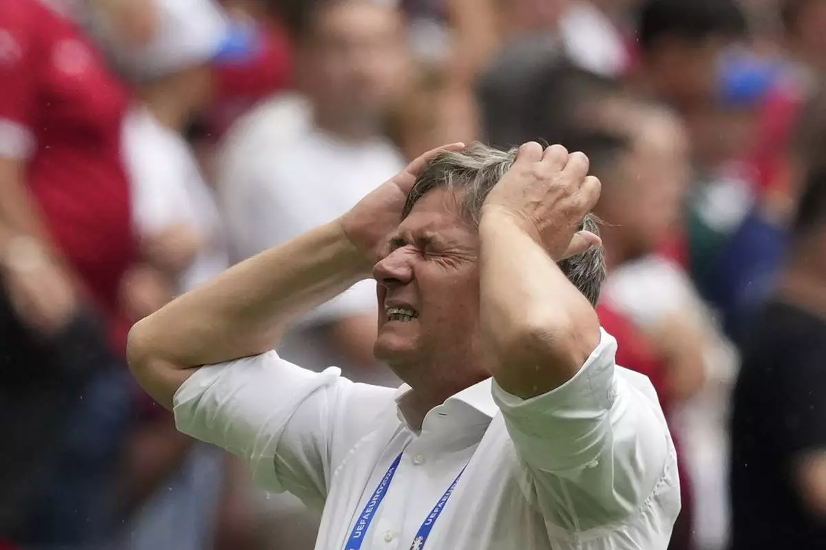 Serbia head coach Dragan Stojkovic reacts after missing a goal-scoring opportunity during the Group C match between Slovenia and Serbia during the Euro 2024 soccer tournament in Munich, Germany, Thursday, June 20, 2024. (AP Photo/Antonio Calanni)