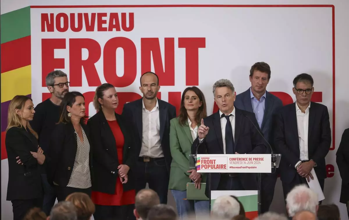 Communist Party national secretary Fabien Roussel, gestures as he speaks during media conference as he is surrounded by leaders of France left-wing coalition for the upcoming election attend a media conference in Paris, Friday, June 14, 2024. Leaders of France's left-wing parties, allied in a coalition known as the New Popular Front on Friday outlined their plan to fend off the far-right from claiming power at the upcoming snap national election. (AP Photo/Thomas Padilla)