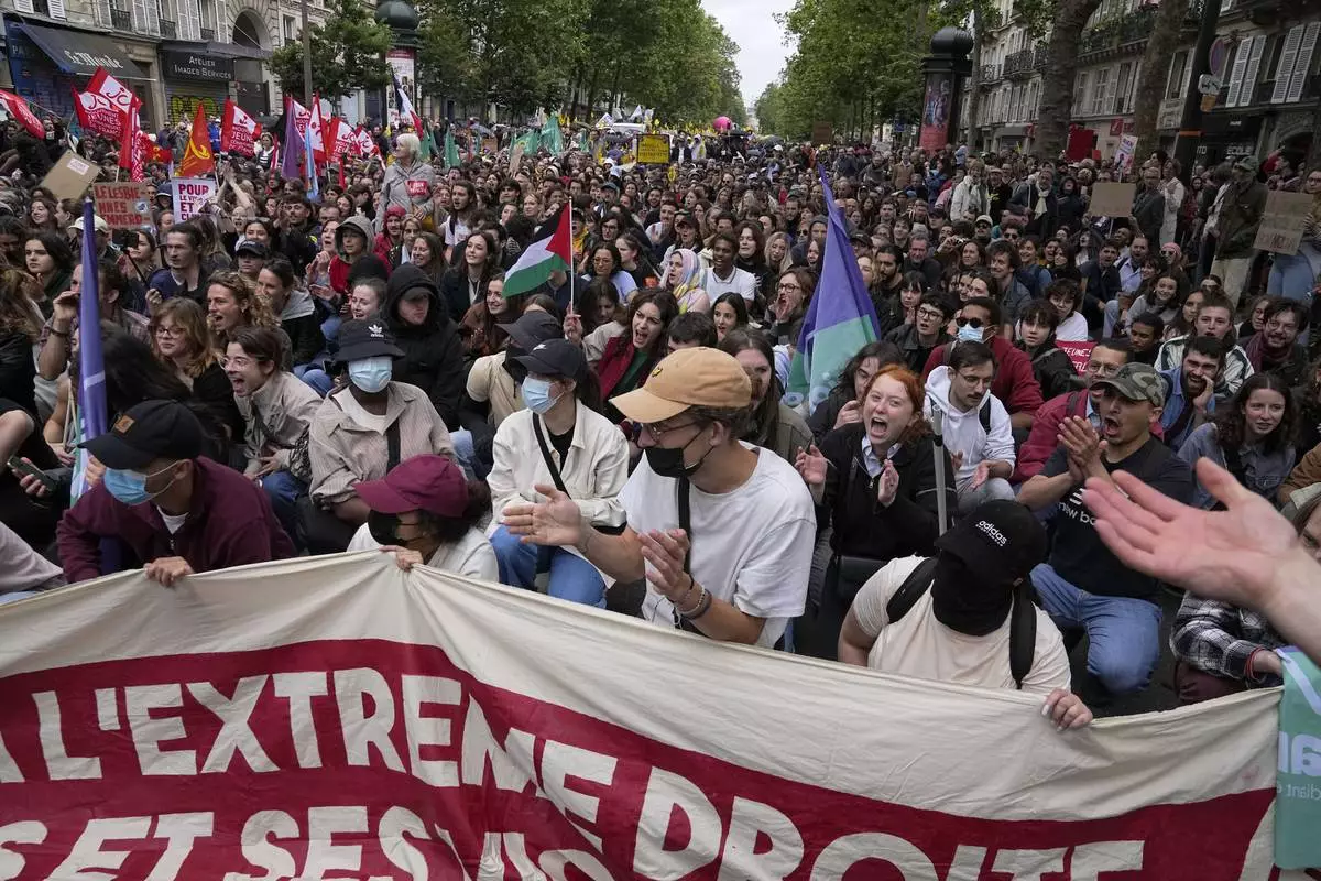 Protesters attend a rally in Paris, Saturday, June 15, 2024. Anti-racism groups joined French unions and a brand-new left-wing coalition in protests in Paris and across France on Saturday against the surging nationalist far right as frenzied campaigning is underway ahead of snap parliamentary elections. (AP Photo/Michel Euler)