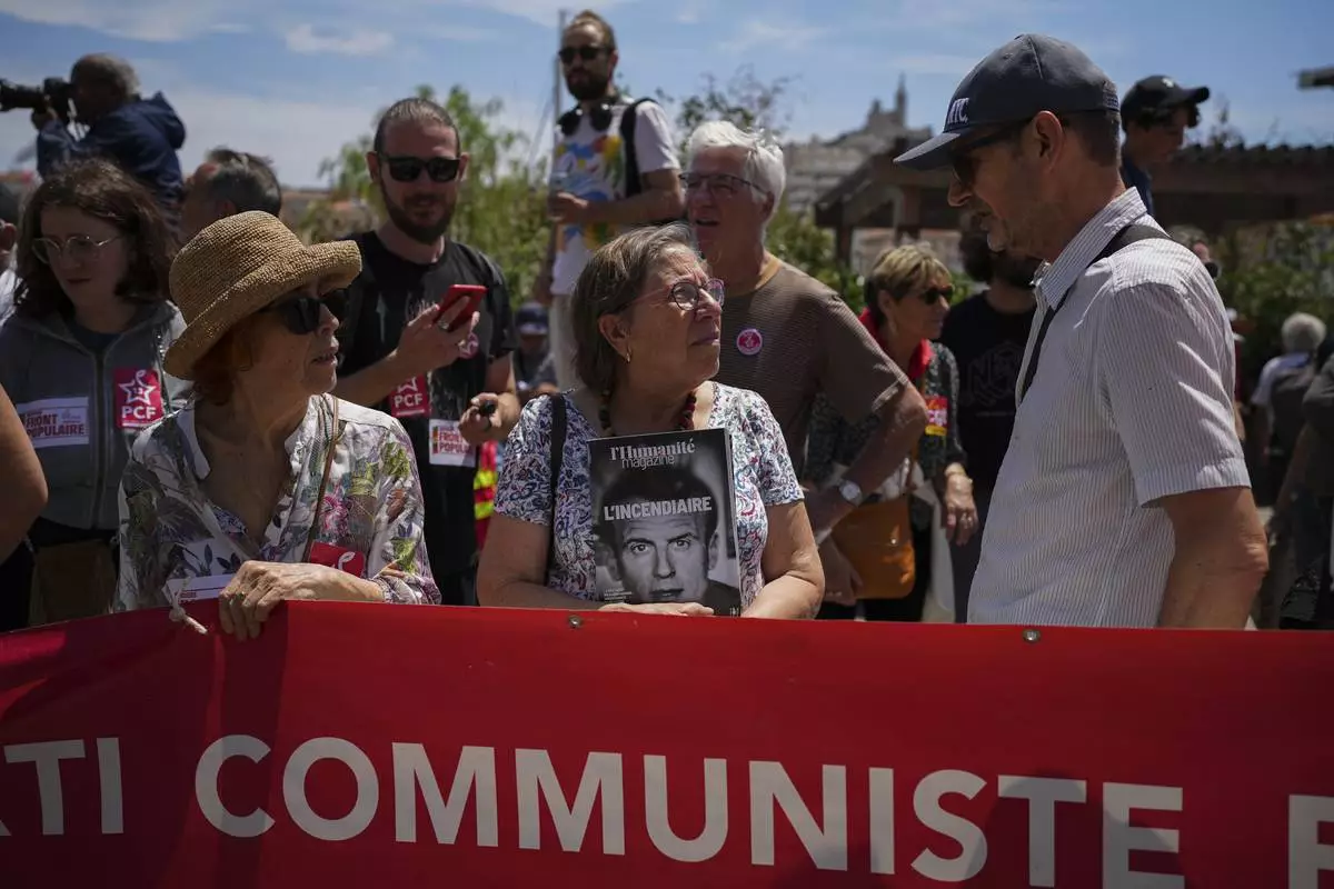 Members of the French communist party march during a demonstration in Marseille, southern France, Saturday, June 15, 2024. Anti-racism groups joined French unions and a brand-new left-wing coalition in protests in Paris and across France on Saturday against the surging nationalist far right as frenzied campaigning is underway ahead of snap parliamentary elections. (AP Photo/Daniel Cole)