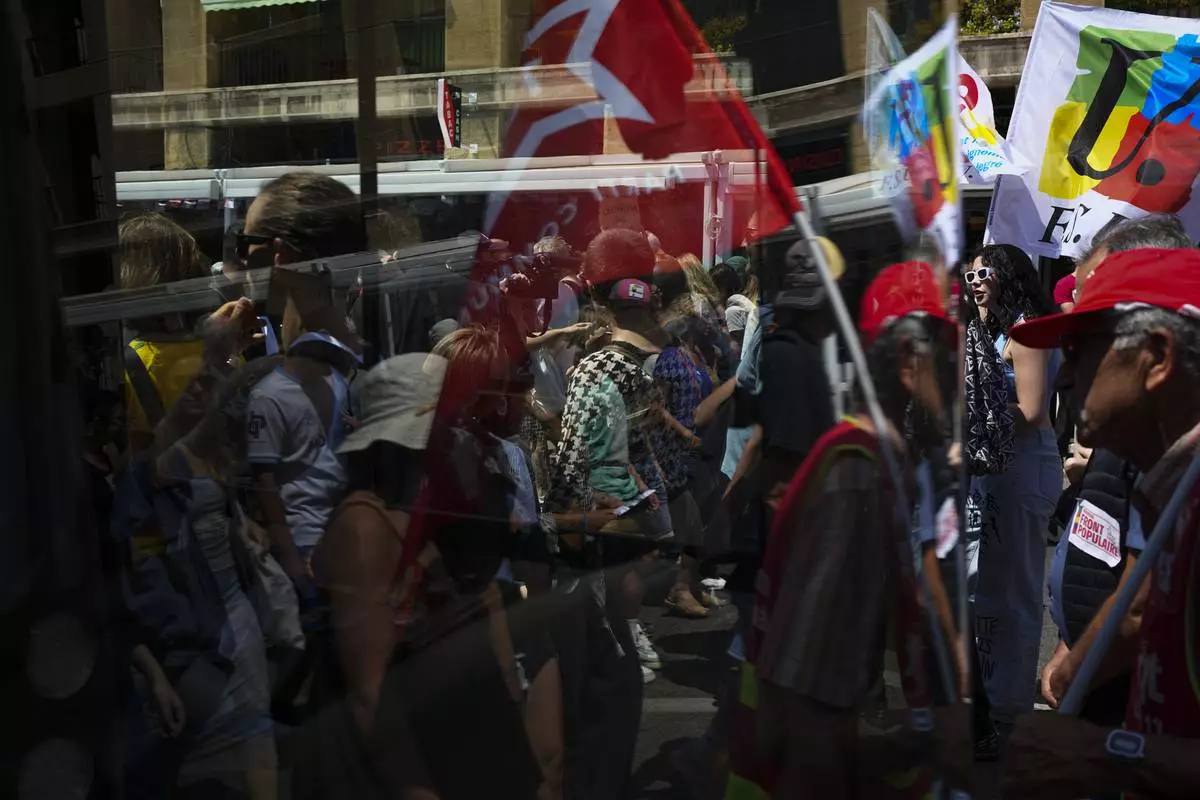 Protesters march during a demonstration in Marseille, southern France, Saturday, June 15, 2024. Anti-racism groups joined French unions and a brand-new left-wing coalition in protests in Paris and across France on Saturday against the surging nationalist far right as frenzied campaigning is underway ahead of snap parliamentary elections. (AP Photo/Daniel Cole)