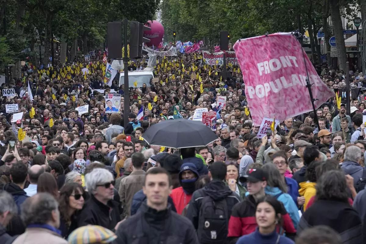 Protesters attend a rally in Paris, Saturday, June 15, 2024. Anti-racism groups joined French unions and a brand-new left-wing coalition in protests in Paris and across France on Saturday against the surging nationalist far right as frenzied campaigning is underway ahead of snap parliamentary elections. (AP Photo/Michel Euler)