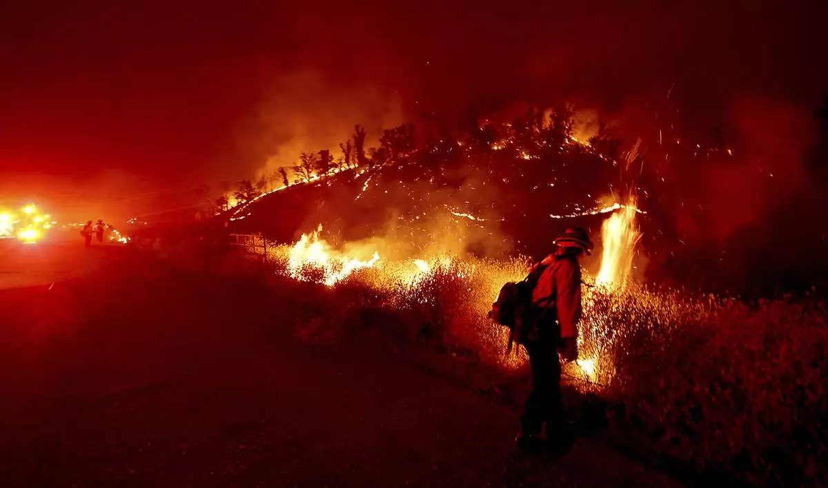 Cal <b>Fire</b> Tuolumne Calaveras firefighter Jamie Bardwell uses a drip torch to...