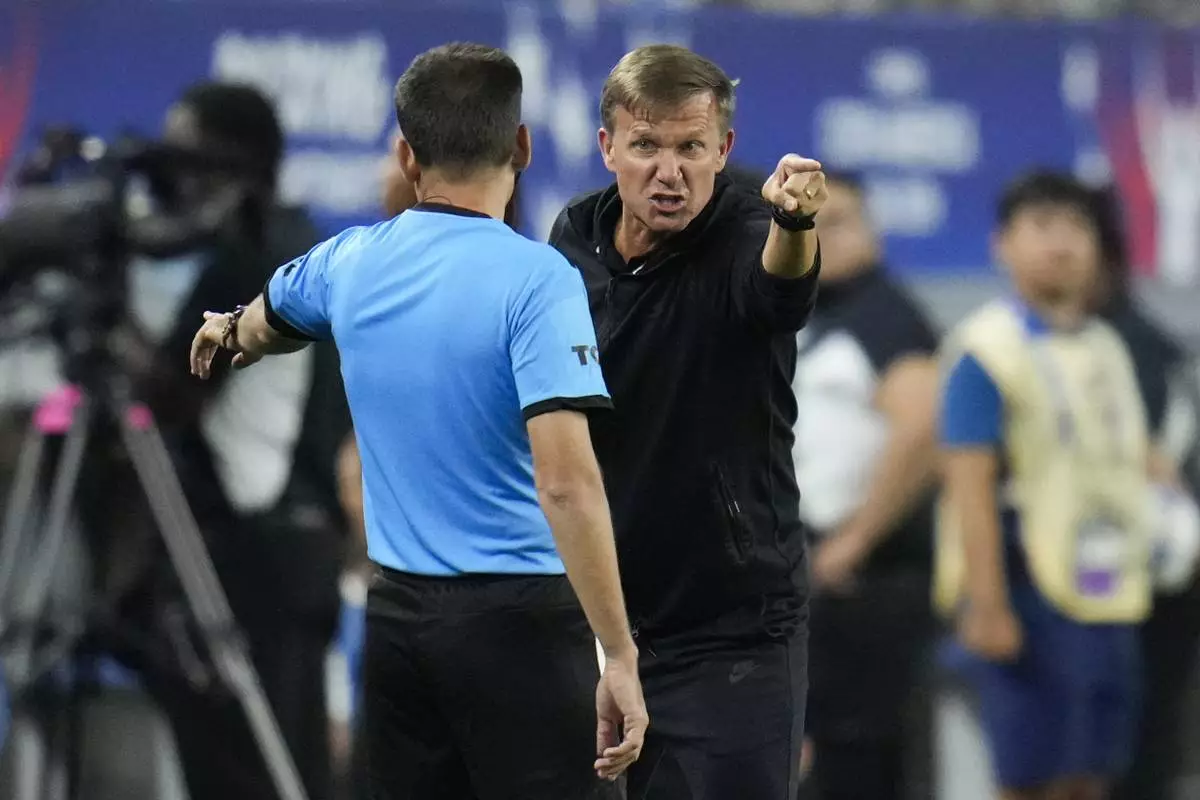 Canada head coach Jesse Marsch, right, disputes a call during a Copa America quarterfinal soccer match between Venezuela and Canada, Friday, July 5, 2024, in Arlington, Texas. (AP Photo/Julio Cortez)