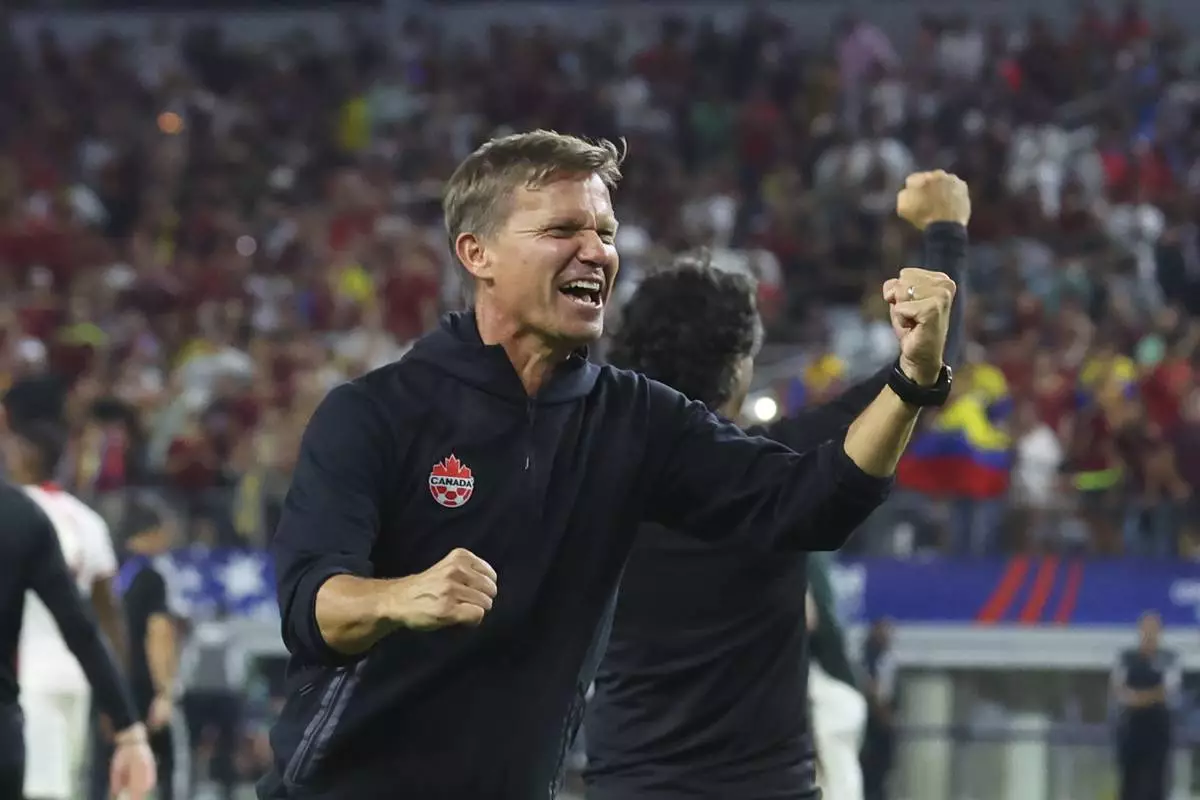 Canada head coach Jesse Marsch celebrates the team's win in a Copa America quarterfinal soccer match between Venezuela and Canada in Arlington, Texas, Friday, July 5, 2024. (AP Photo/Richard Rodriguez)