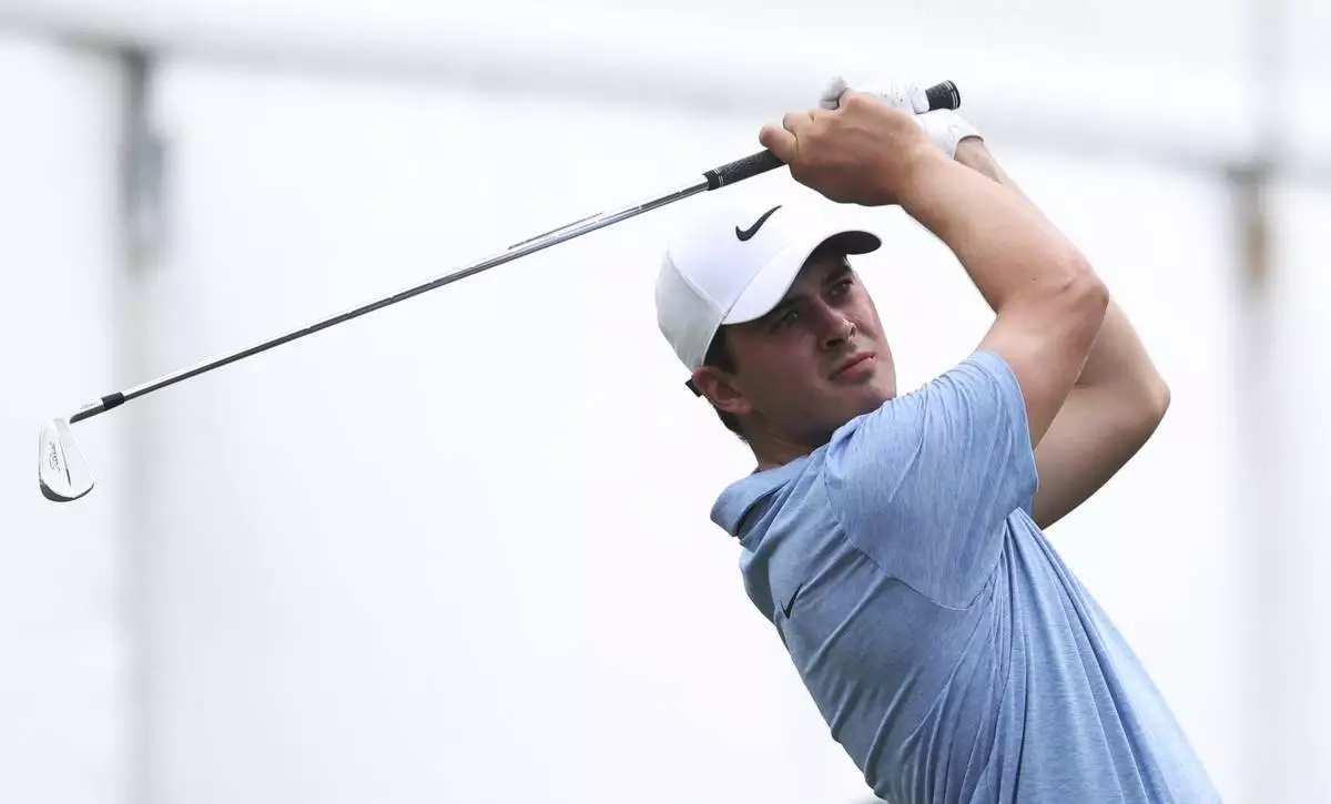 Davis Thompson follows through on his seventh hole tee shot at the John Deere Classic golf tournament Friday, July 5, 2024, at TPC Deere Run in Silvis, Ill. (Roy Dabner/Quad City Times via AP)