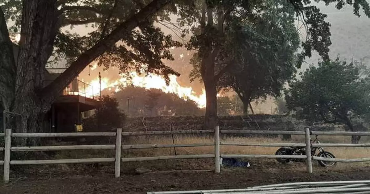 Lightning and a burning car pushed into a gully are blamed for wildfires scorching the West