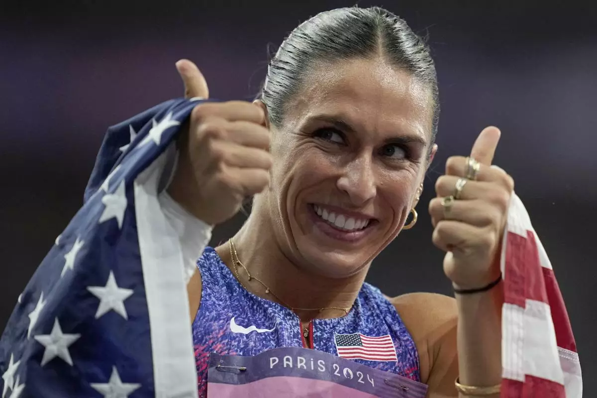 Valarie Allman, of the United States, gestures after winning the gold medal in the women's discus throw final at the 2024 Summer Olympics, Monday, Aug. 5, 2024, in Saint-Denis, France. (AP Photo/Ashley Landis)