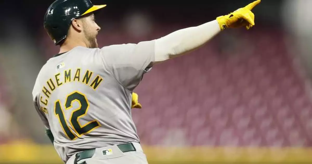 A's hit 3 late homers after quiet start and hold off Reds 5-4