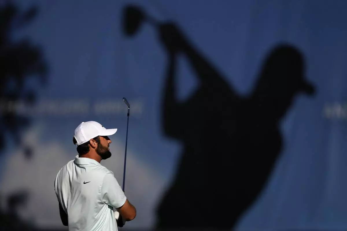 Scottie Scheffler tees off on the driving range before the third round of the BMW Championship golf event at Castle Pines Golf Club on Saturday, Aug. 24, 2024, in Castle Rock, Colo. (AP Photo/Matt York)