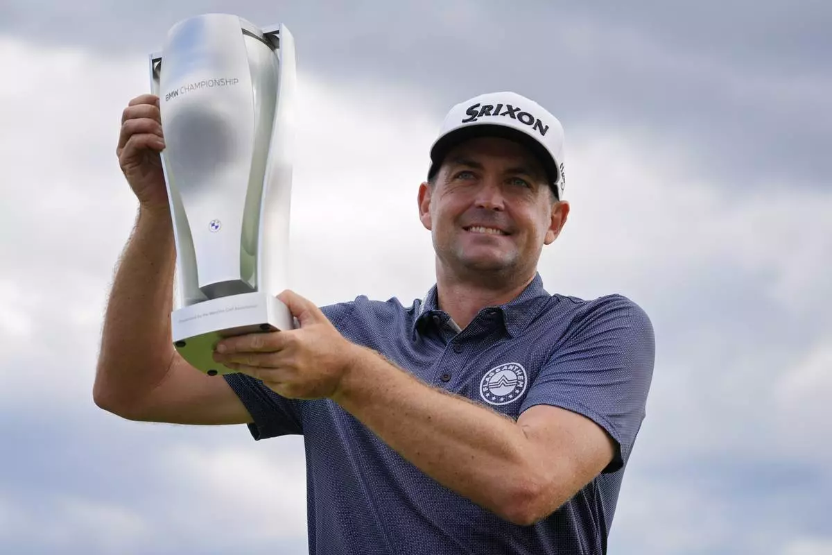 Keegan Bradley holds up the BMW Championship trophy after winning the BMW Championship golf event at Castle Pines Golf Club on Sunday, Aug. 25, 2024, in Castle Rock, Colo. (AP Photo/Matt York)