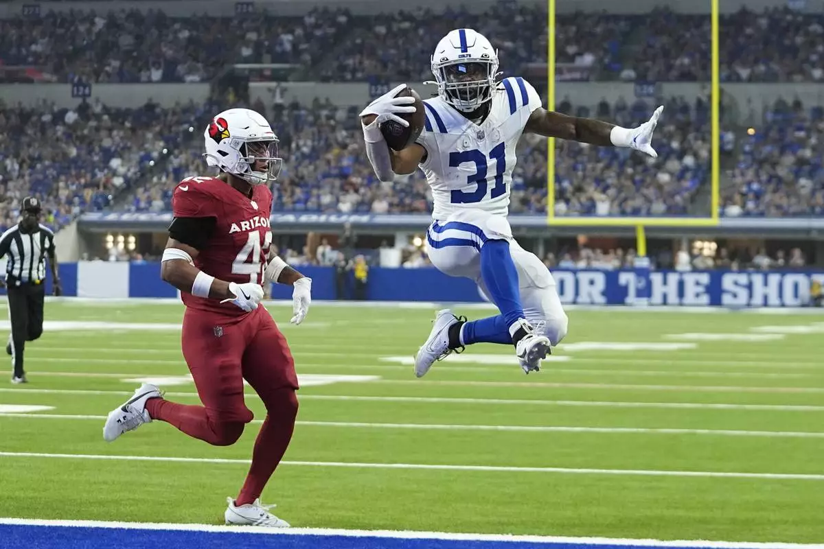 Indianapolis Colts running back Tyler Goodson (31) beats Arizona Cardinals safety Dadrion Taylor-Demerson for a touchdown during the first half of a preseason NFL football game, Saturday, Aug. 17, 2024, in Indianapolis. (AP Photo/Darron Cummings)