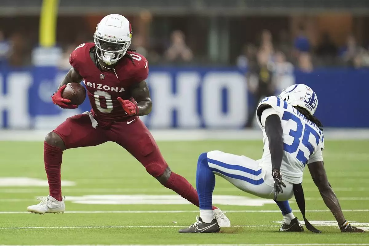 Arizona Cardinals wide receiver Zach Pascal (0) runs past Arizona Cardinals safety Verone McKinley III (35) during the first half of a preseason NFL football game, Saturday, Aug. 17, 2024, in Indianapolis. (AP Photo/Michael Conroy)
