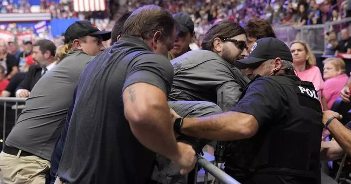 Police say a man will face charges after storming into the press area at a Trump rally