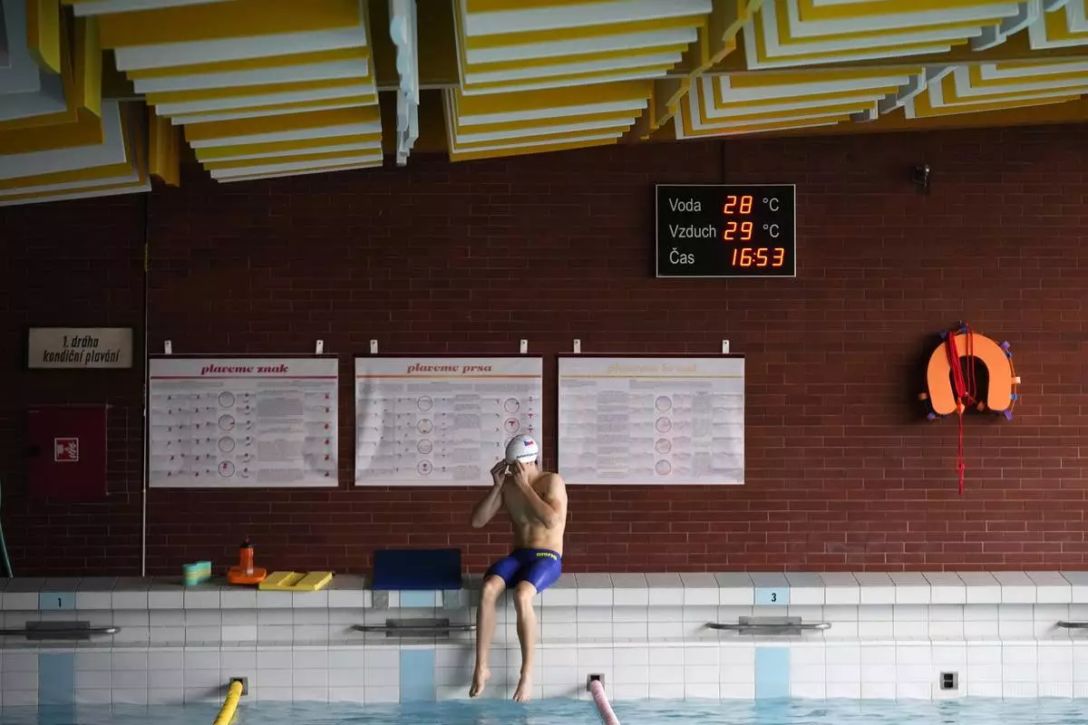 Teenage swimmer David Kratochvil gets ready for his training in Tachov, Czech Republic, Wednesday, July 3, 2024. (AP Photo/Petr David Josek)