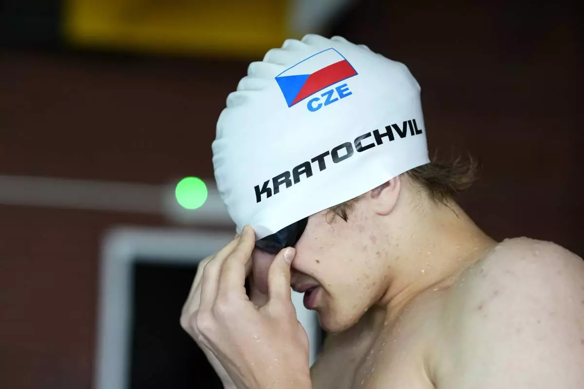 David Kratochvil, a teenage swimmer who prepares for the Paralympic Games in Paris, gets ready for his training in Tachov, Czech Republic, Wednesday, July 3, 2024. (AP Photo/Petr David Josek)