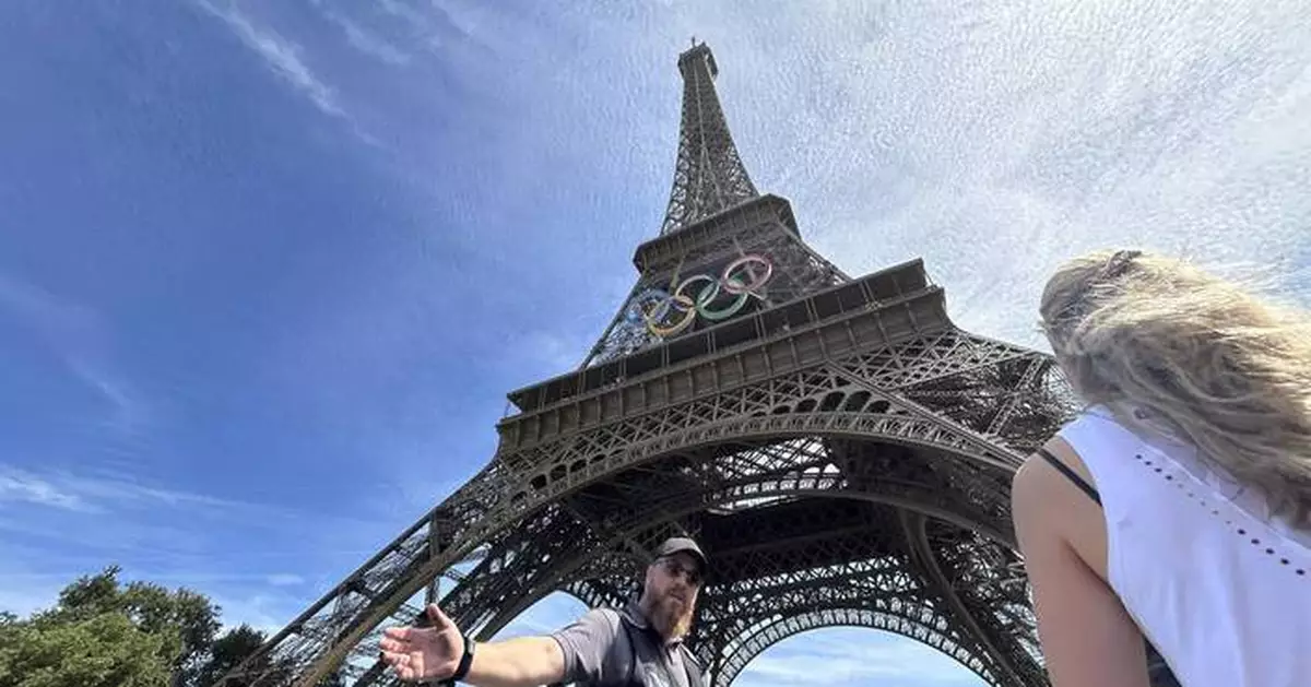 Police arrest a man climbing the Eiffel Tower, prompting an evacuation hours before closing ceremony