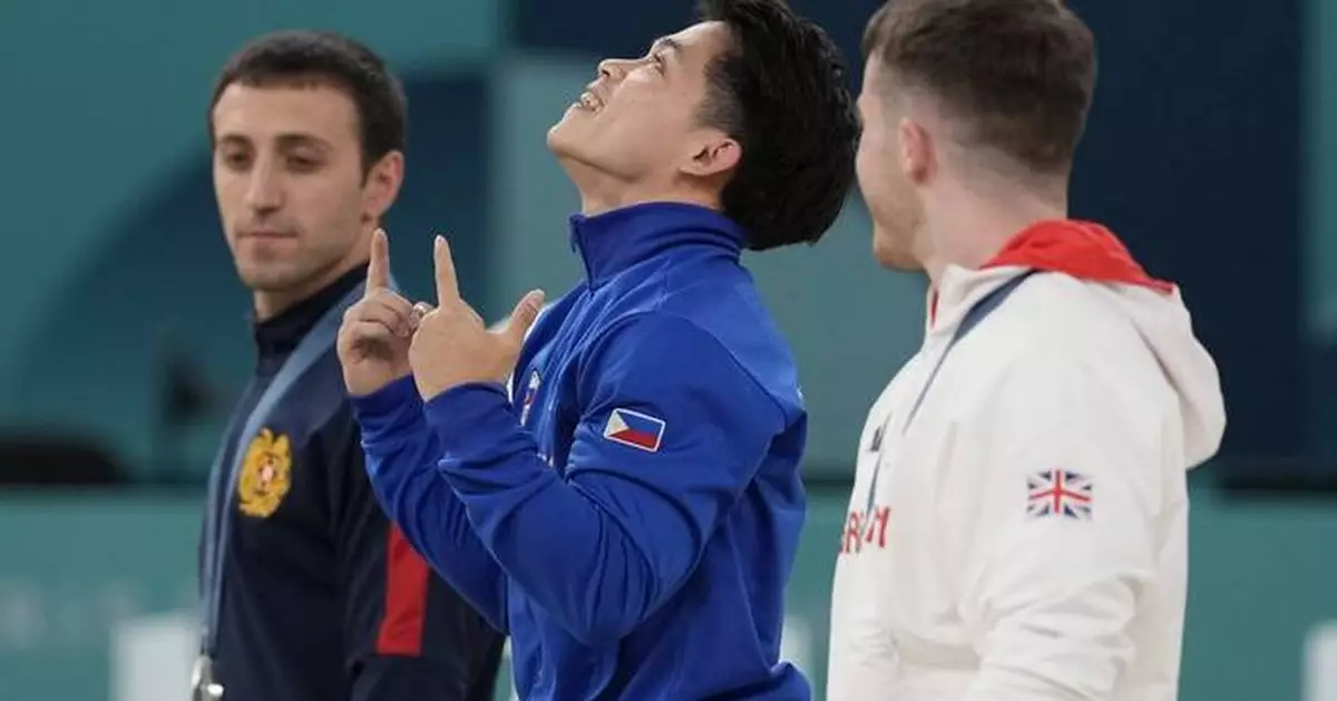 Filipino gymnast who won 2 Olympic golds in Paris gets hero's welcome and free buffets for life