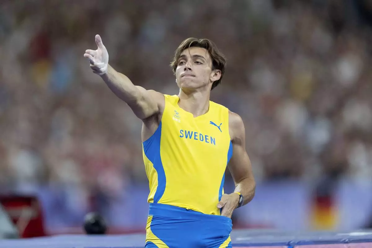Armand Duplantis, of Sweden, reacts after setting a new Olympic record in the men's pole vault final at the 2024 Summer Olympics, Monday, Aug. 5, 2024, in Saint-Denis, France. (AP Photo/David Goldman)