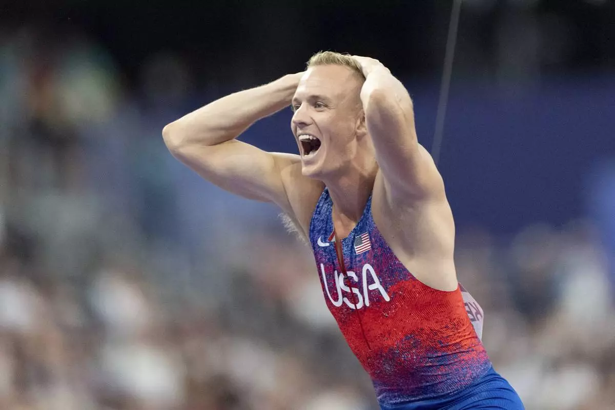 Sam Kendricks, of the United States, reacts after winning the silver medal in the men's pole vault at the 2024 Summer Olympics, Monday, Aug. 5, 2024, in Saint-Denis, France. (AP Photo/David Goldman)