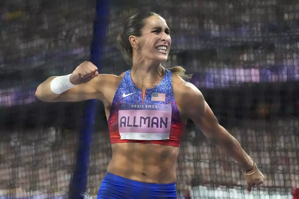 Valarie Allman, of the United States, celebrates after winning the women's discus throw final at the 2024 Summer Olympics, Monday, Aug. 5, 2024, in Saint-Denis, France.(AP Photo/Matthias Schrader)