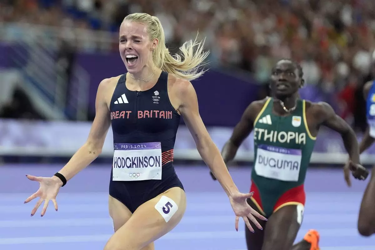 Keely Hodgkinson, of Britain, celebrates after winning the women's 800-meters final at the 2024 Summer Olympics, Monday, Aug. 5, 2024, in Saint-Denis, France. (AP Photo/Matthias Schrader)