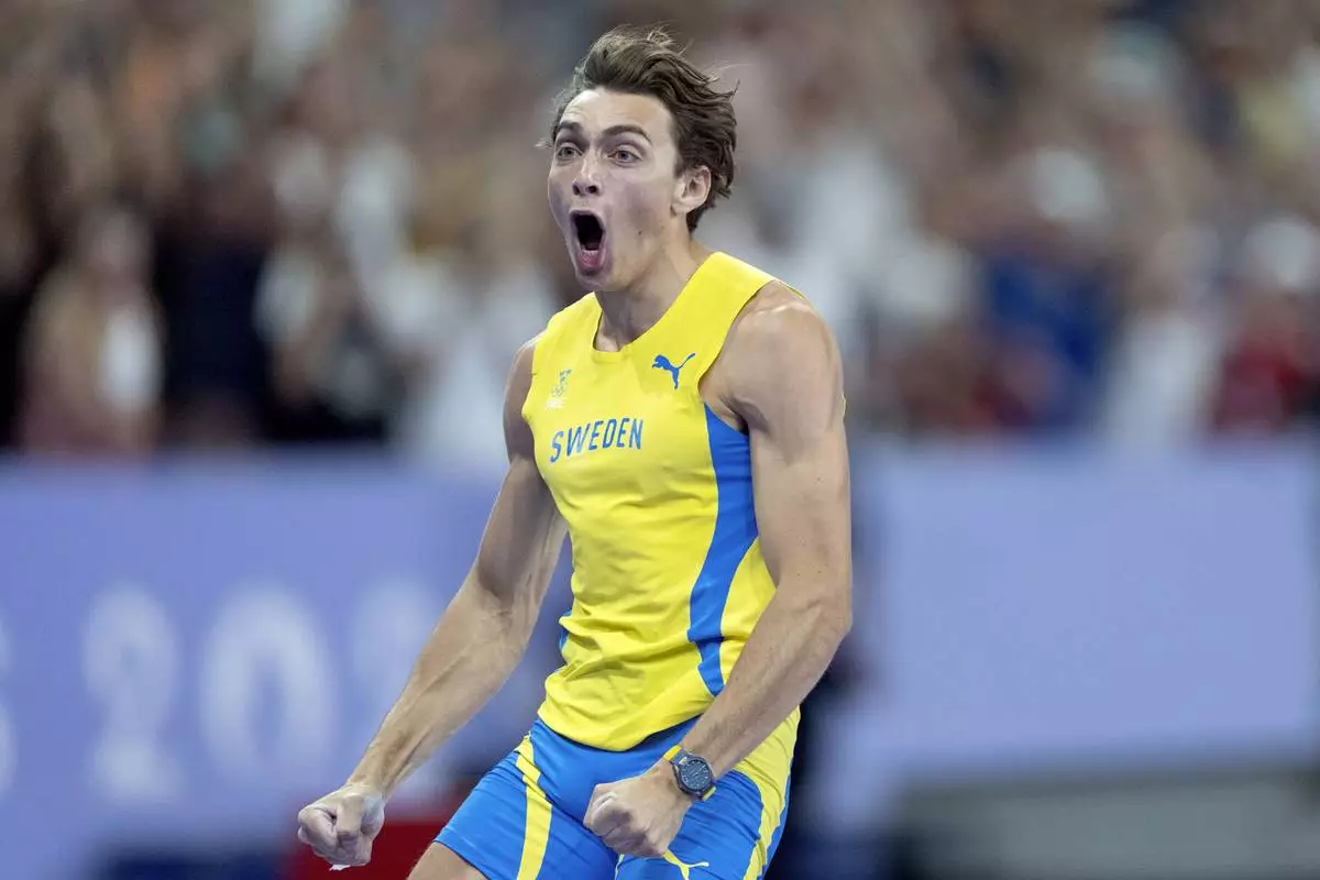Armand Duplantis, of Sweden, reacts after setting a new world record in the men's pole vault final at the 2024 Summer Olympics, Monday, Aug. 5, 2024, in Saint-Denis, France. (AP Photo/David Goldman)