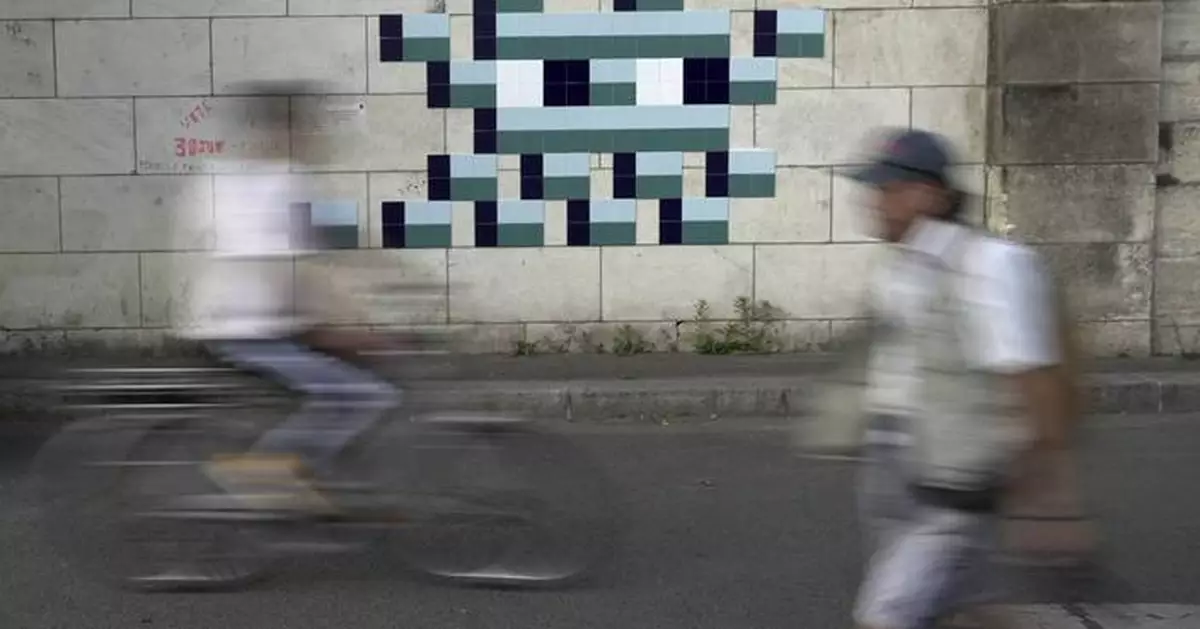 Mystery Paris street artist 'Invader' glues up new work to celebrate Olympics and delight fans