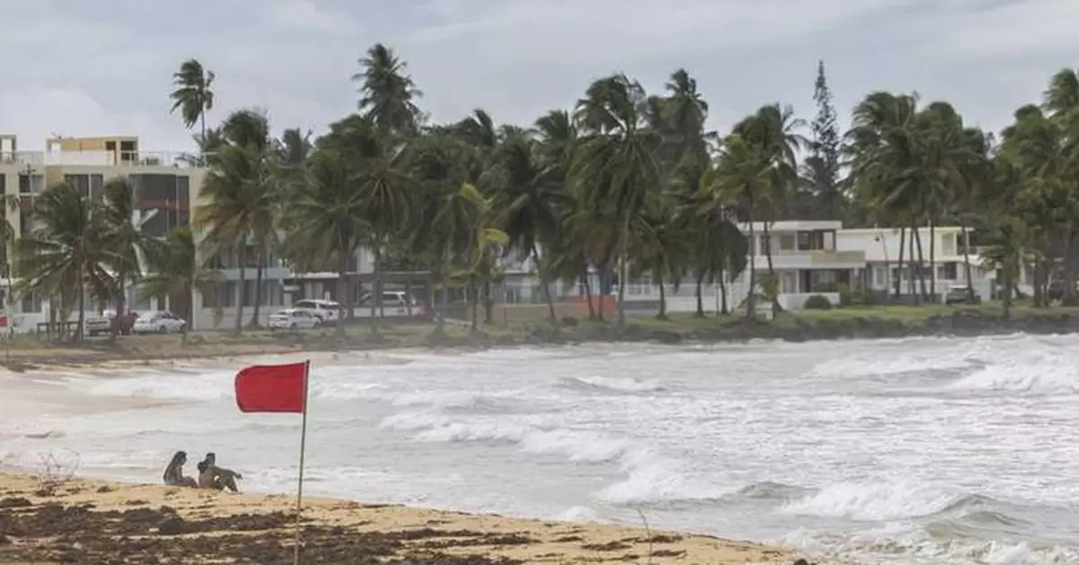 Hurricane Ernesto drops torrential rain on Puerto Rico as it strengthens heading toward Bermuda