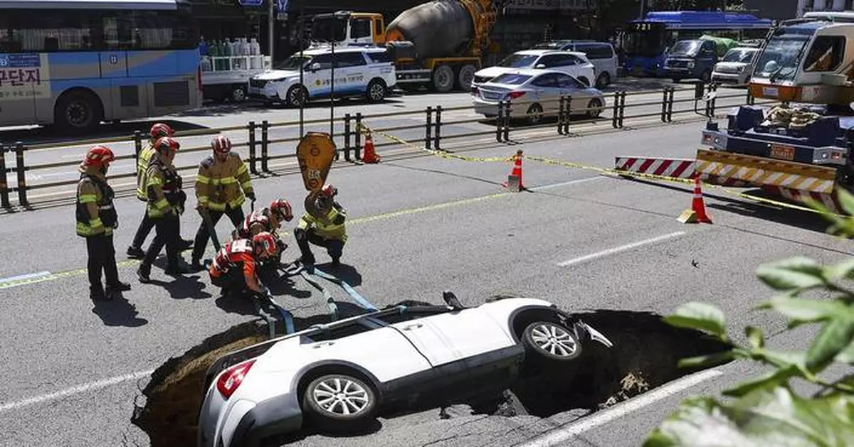 A sinkhole swallows an SUV in South Korea, injuring 2 people