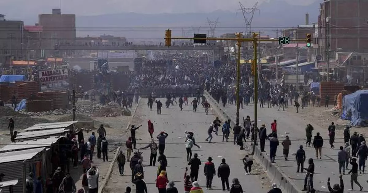 Rival protesters clash in Bolivia as ex-President Evo Morales leads a march to the capital