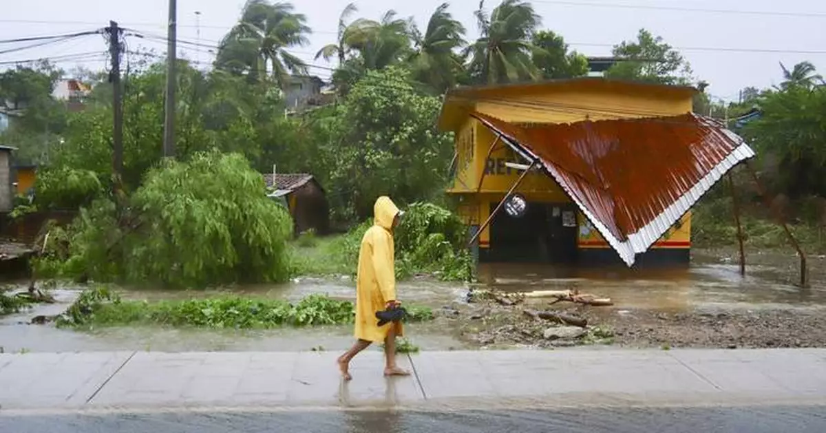 John as a tropical storm hits Mexico's Pacific coast a 2nd time