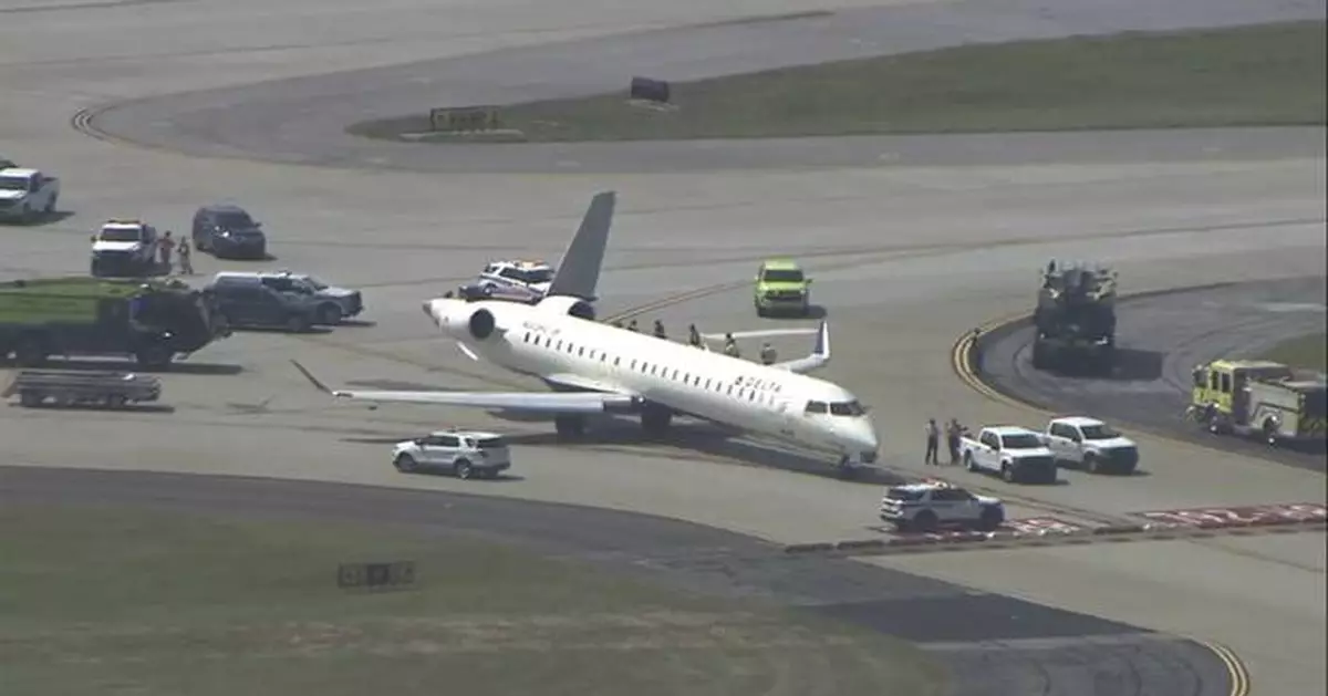 Two Delta planes collide on an Atlanta taxiway, knocking the tail off one