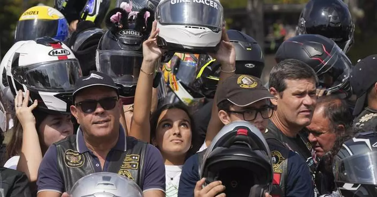 An estimated 180,000 motorcyclists converge at Portuguese shrine to have their helmets blessed.