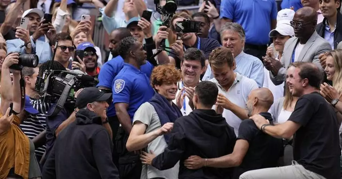 Jannik Sinner gets a hug from his friend Seal after winning the US Open title