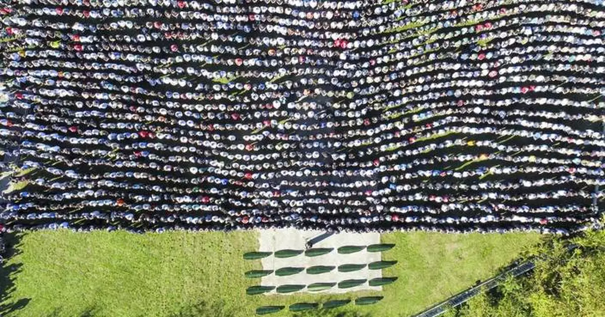 Several thousand attend a funeral service in southern Bosnia for 19 killed in devastating floods